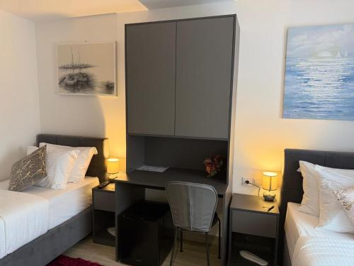 a bedroom with a desk and a bed and a chair at Alsago Lux in Sesvete