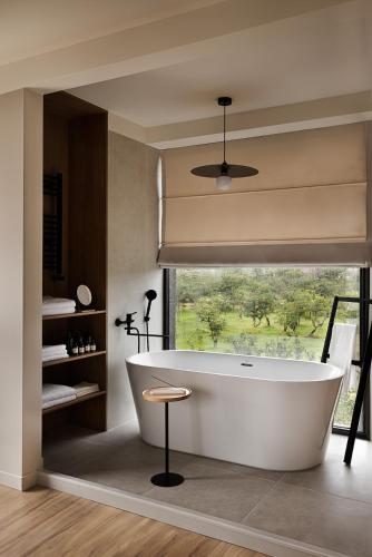 a bath tub in a bathroom with a window at Wabi-Sabi - 2br Private Villa in Batumi
