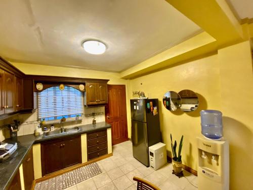 a kitchen with a sink and a refrigerator at Cindys Getaway in Ulot
