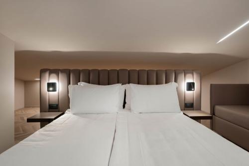 Cama o camas de una habitación en Aurora ApartHotel