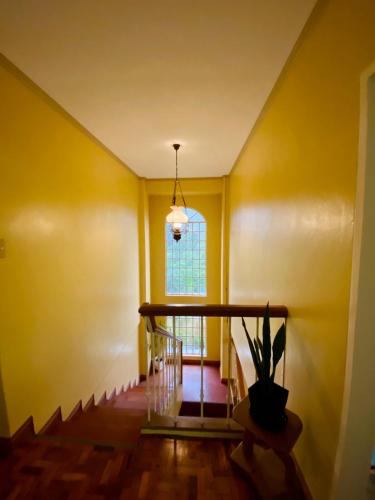 a hallway with yellow walls and a window at Cindys Getaway in Ulot