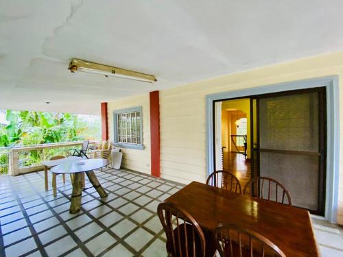 a porch with a table and chairs on a balcony at Cindys Getaway in Ulot