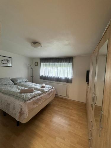 a bedroom with a bed and a large window at Beautiful apartment in the heart of Keflavik in Keflavík