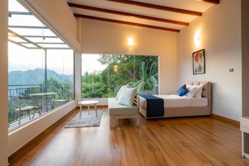 a bedroom with a bed and a balcony at Tranquility Ella in Ella