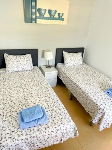 a bedroom with two beds with towels on them at Casa Enda - Blue Sky Property Management in Fuensalida