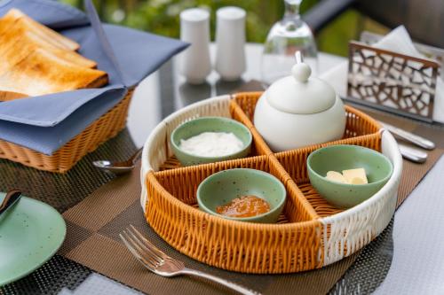 a tray with four bowls and a teapot on a table at Tranquility Ella in Ella