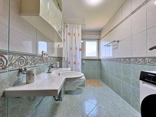 a bathroom with a sink and a shower at Apartments Vodopija in Soline