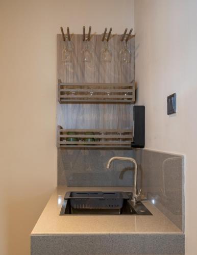 a kitchen with a sink with wine glasses at Tranquility Ella in Ella
