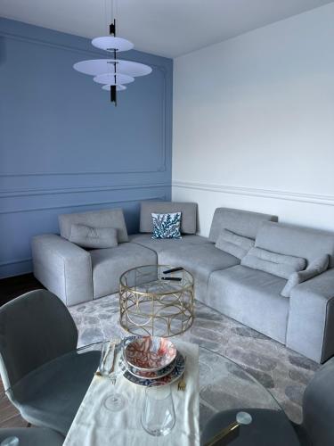 a living room with a couch and a table at Azurno Pristaniste 3 in Njivice