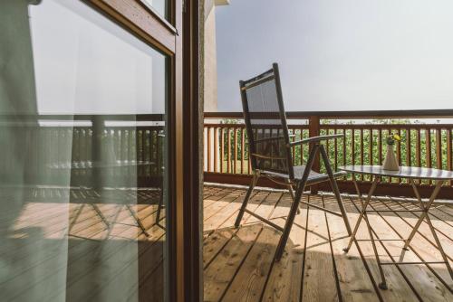 a chair and a table on a balcony at Hotel & Spa Larimar in Stegersbach
