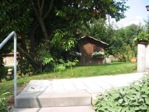 a small woodenshed in a yard with a grass field at Ferienwohnungen Manz in Überlingen