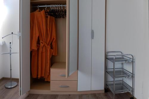 a closet with white cabinets and a mirror at Ferienwohnungen Manz in Überlingen