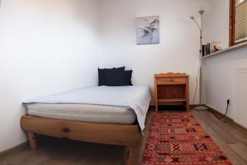 a bedroom with a bed and a table and a rug at Ferienwohnungen Manz in Überlingen