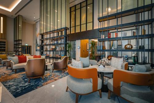 a lobby of a hotel with chairs and a table at First Grand Hotel in Dammam