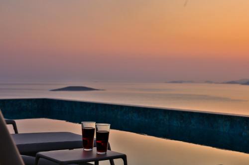 two glasses of beer sitting on a table on a balcony at Lyxos Hotel in Kas