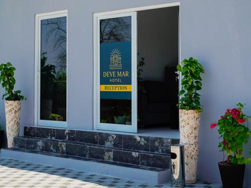 a sign on the front door of a house at Deve Mar Hotel in Borsh