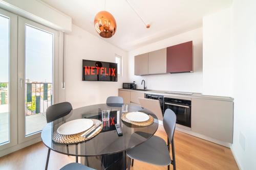 a dining room with a table and chairs in a kitchen at Luminosissimo Attico con Vista Panoramica su Udine in Udine