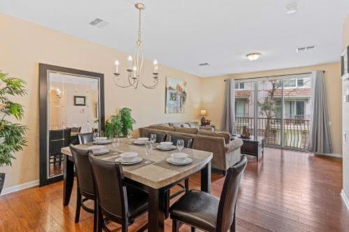a dining room and living room with a table and chairs at 3-Story sanctuary Condo in the heart of Orlando85 in Orlando