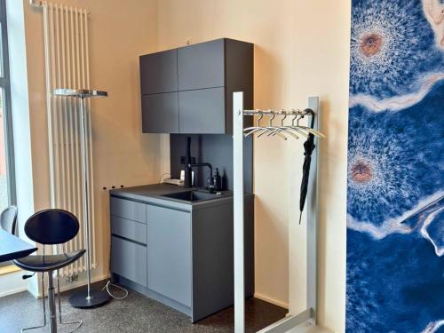 a kitchen with a sink and a cabinet in a room at Isaak Apartment Löwenbau E1-W06 in Waldshut-Tiengen