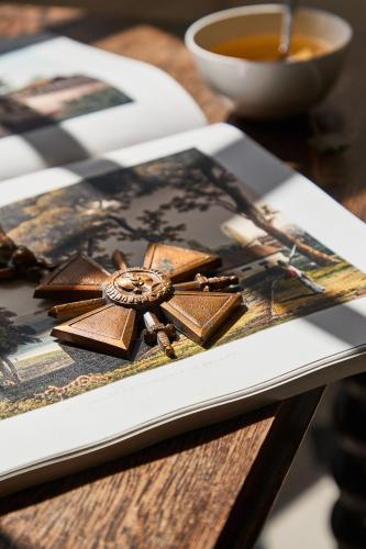 a plate with chocolate on a table with a cup of tea at Villa Arthus-Bertrand in Noirmoutier-en-l'lle
