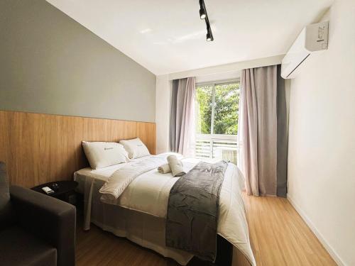 a bedroom with a bed and a window at UniHome Niterói by Housi in Niterói