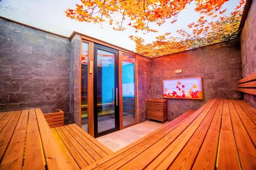a room with wooden benches and a large window at Grand Hotel Therme in Banya