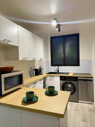 a kitchen with a table with two bowls on it at Appartement Bel Azur in Fort-de-France