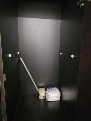 a bathroom with a toilet with a trash can in it at Walk to Temples in Chhatikara