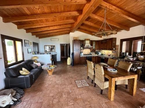 a living room with a couch and a table at Casa Golfo Asinara,Ocean view, private pool, fully air-conditioned, secluded location in Trinità dʼAgultu
