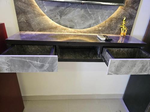 a marble counter with a sink in a room at Walk to Temples in Chhatikara