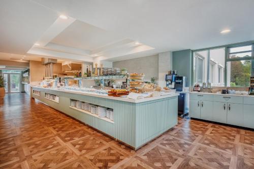 a large kitchen with a large counter in a room at IFA Graal-Müritz Hotel & Spa in Graal-Müritz