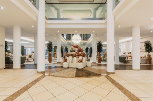 a lobby with columns and a christmas tree at IFA Graal-Müritz Hotel & Spa in Graal-Müritz
