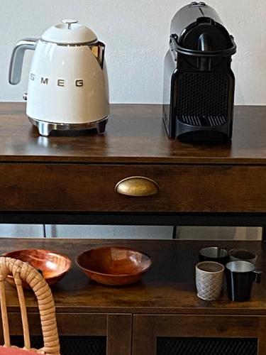a coffee maker and a blender on a wooden table at La Closerie de la Riviere, Sisteron Bevons in Bevons