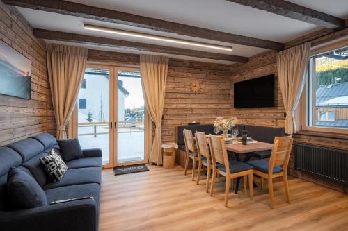a living room with a blue couch and a table at Wellness apartmány BARTH Holiday in Dolní Morava