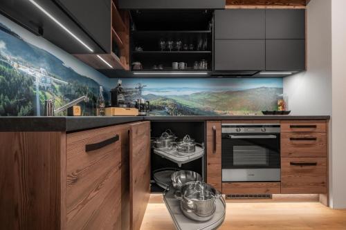 a kitchen with a large painting on the wall at Wellness apartmány BARTH Holiday in Dolní Morava