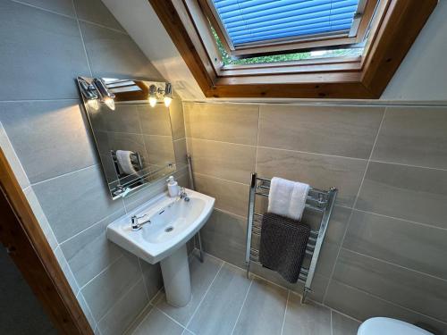 a bathroom with a sink and a mirror at May Cottage in Bridlington