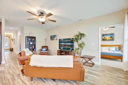 a living room with a couch and a ceiling fan at SeaBreeze On David in Shalimar