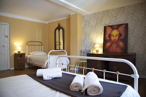 a bedroom with a bed with towels on it at Autour d'une Toile in Rouvenac