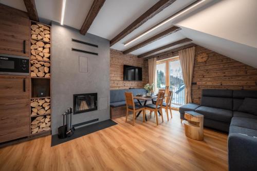 a living room with a couch and a fireplace at Wellness apartmány BARTH Holiday in Dolní Morava