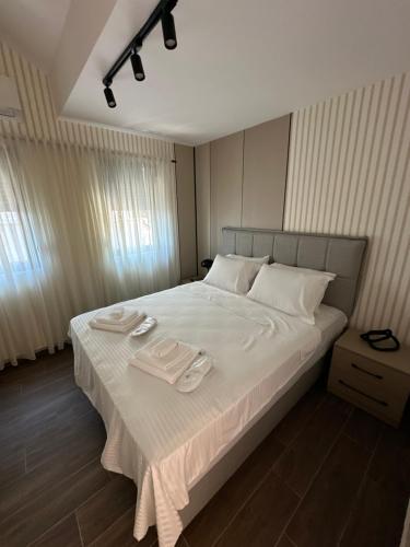 a large bed with two plates and towels on it at Azurno Pristaniste 1 in Njivice