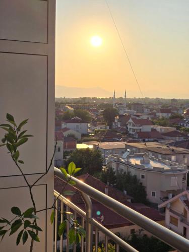 a view of the sunset from the balcony of a building at Feel like home 1 in Shkodër