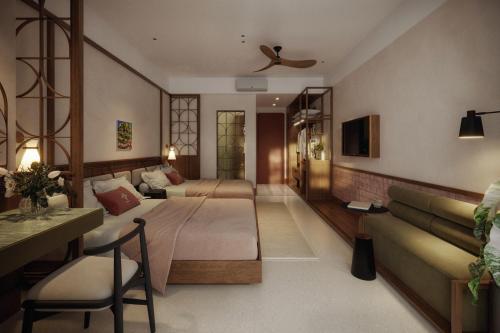 a living room with two beds and a couch at Magnolia Boutique Hue in Thôn Trường Giang