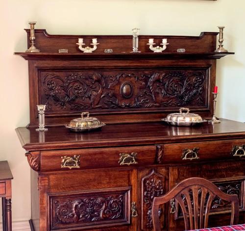 a wooden dresser with two dishes on top of it at Parteen A Lax, River House & Gardens in Limerick