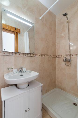 a bathroom with a sink and a mirror and a tub at Home2Book Charming Rooftop Vibes Apartment in Santa Maria de Guia de Gran Canaria