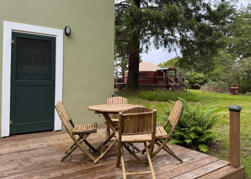 a wooden table and chairs on a wooden deck at MobyDick Hotel in Ocean Park