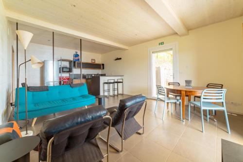 a living room with a blue bench and a table at The Casalo in Finale Ligure