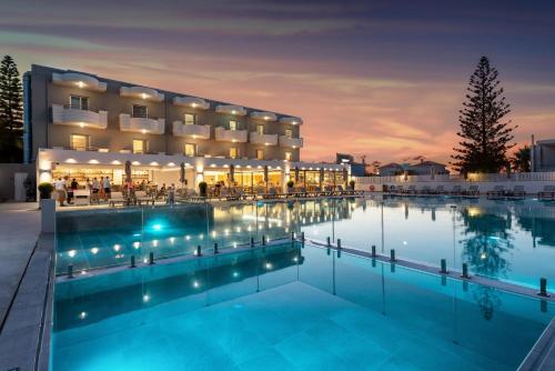 a hotel with a swimming pool at night at Dore Boutique Hotel in Agia Marina Nea Kydonias