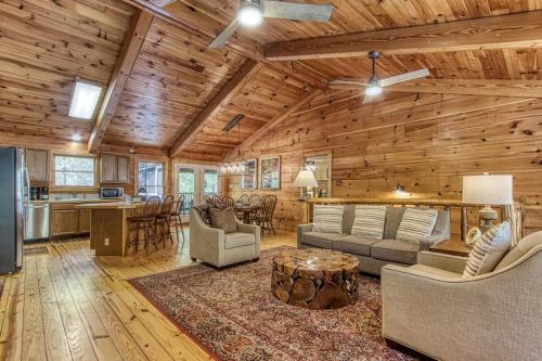 a living room with a couch and a table at Cades Cove Escape By Avada Properties in Townsend