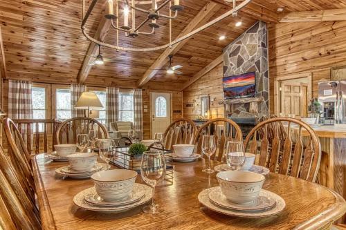 a dining room with a wooden table and chairs at Cades Cove Escape By Avada Properties in Townsend