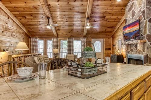 a kitchen and living room with a table and chairs at Cades Cove Escape By Avada Properties in Townsend